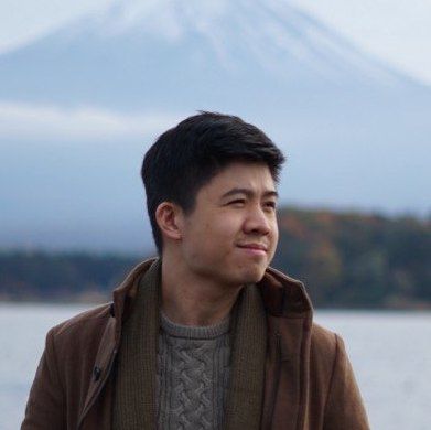 Euwyn Goh outdoors, with a mountain and lake behind him
